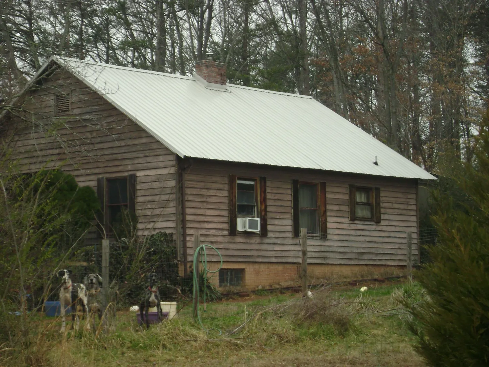 White metal roof on an old wood sided farmhouse, from a Metal Roof Installation job in Emerado